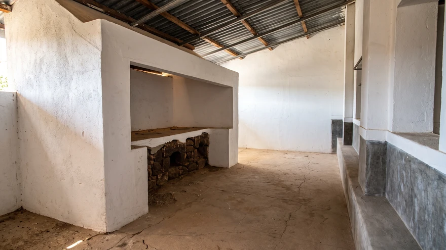 Empty whitewashed kitchen room inside the Tarrafal concentration camp museum