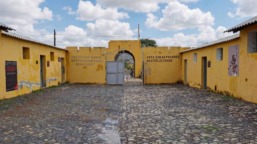 Inner courtyard with yellow walls and political slogans at the Tarrafal concentration camp