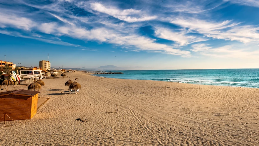 Wide empty sandy stretch of Western Beach in Gibraltar under a bright sky